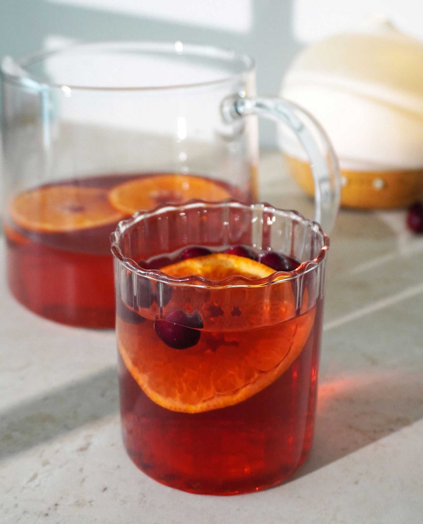 Red herbal tea infusion by Blissblends steeped from Glow Getter, a herbal tea blend promoting blemish free skin and daily gut support.
