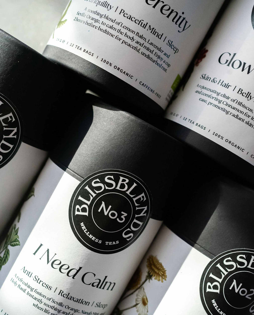 Close-up of BlissBlends functional herbal teas – a premium apothecary wellness tea collection for whole body wellness, featuring recycable paper tubes with natural teas made for beauty, balance, and deep nourishment.