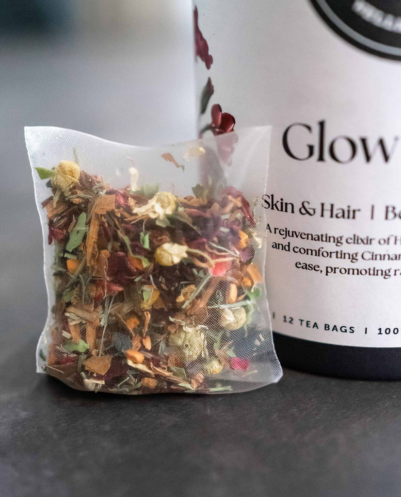 Glow Getter herbal teabag by BlissBlends – anti-bloating and acne-clearing beauty tea with hibiscus, caraway, and cinnamon for gut reset and radiant and glowing skin from within.