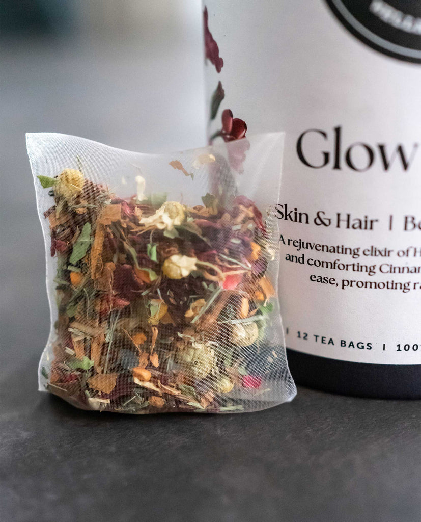Organic beauty tea in compostable tea bag, supporting anti-bloating, energy, and clear skin naturally from within.